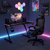 Lifestyle Image of A Gaming Room with HUZARO HERO 2.5 RGB LED GAMING DESK - LED Lighting - Headphone & Cup Holders - Cable Ports with Monitor & Speakers on Desk Top & Huzaro Force 3.7 Carbon Black Ergonomic Gaming Chair with Footrest, Lumbar Cushion & Ne