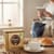 Nescafe Gold Blend Instant Coffee Granules 750g beside a cup of fresh coffee on a coffee table in a living room at home